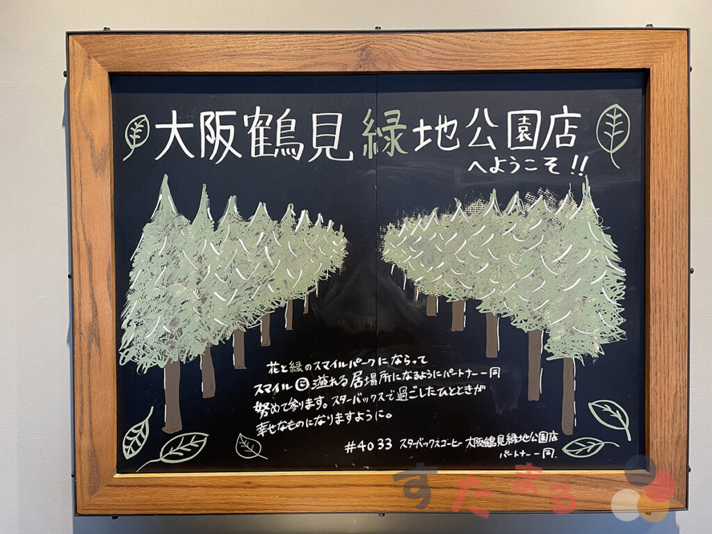 スターバックスコーヒー 大阪鶴見緑地公園店に飾られている鶴見緑地の緑が溢れる並木が描かれたウェルカムプレート