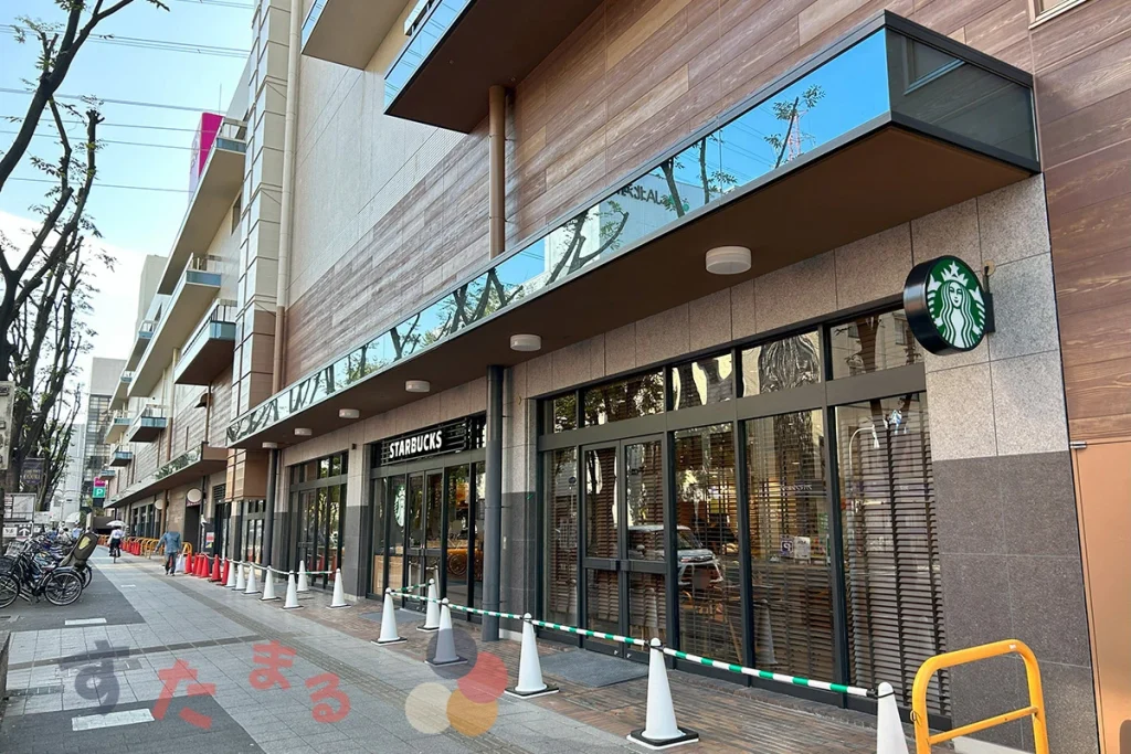 starbucks coffee イオン古川橋駅前店の屋外入口とその周りのウッディ外壁の写真